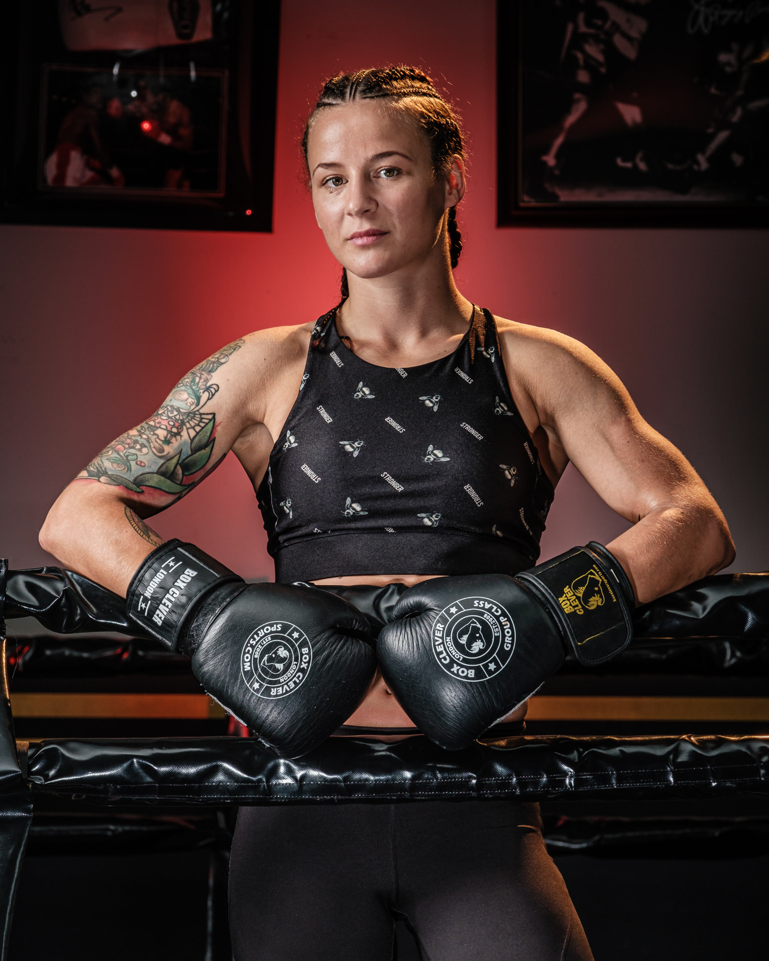 Marija in the ring with boxing gloves resting on the ropes