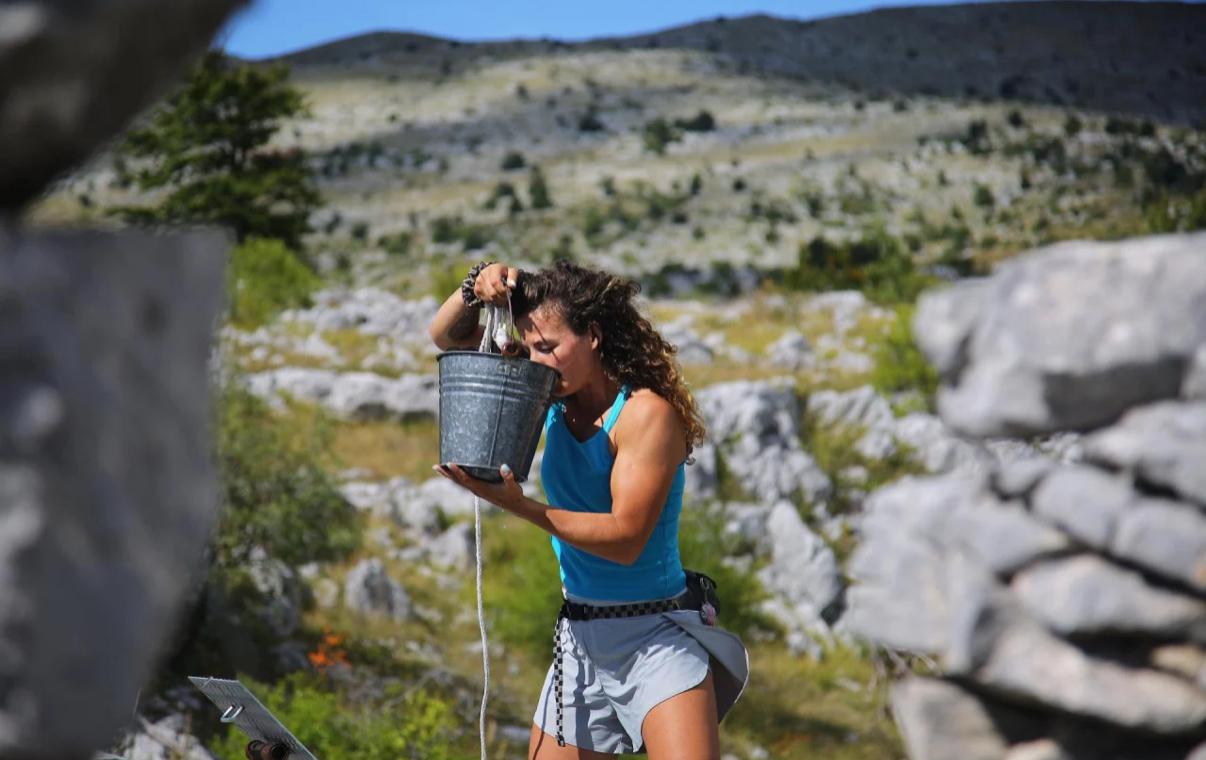 Drawing cold water from the well in the midday sun