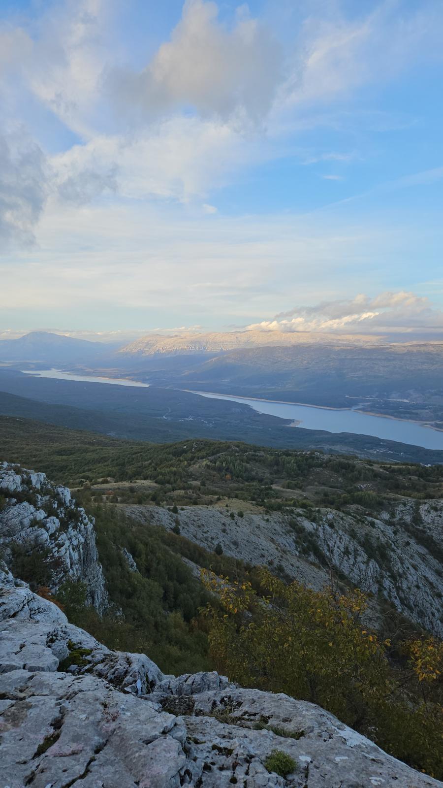 The lake far below, seen from the cliff edge