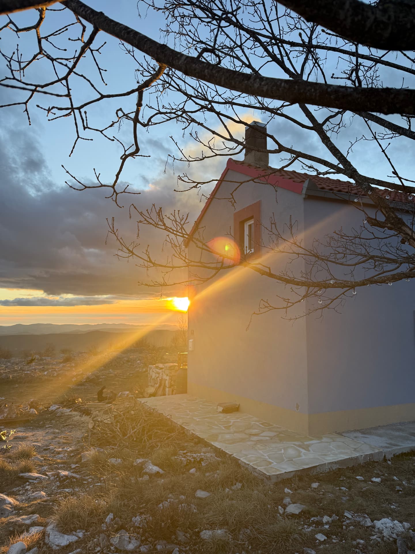 Morning sun over the house and the meadow