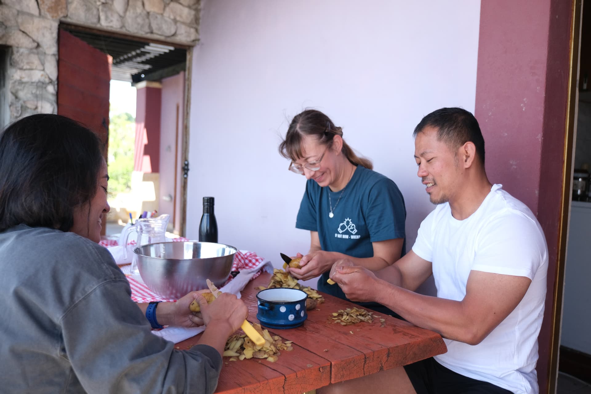 Peeling potatoes together on the shaded porch before dinner